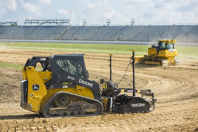 John Deere track loader with grade control attachment