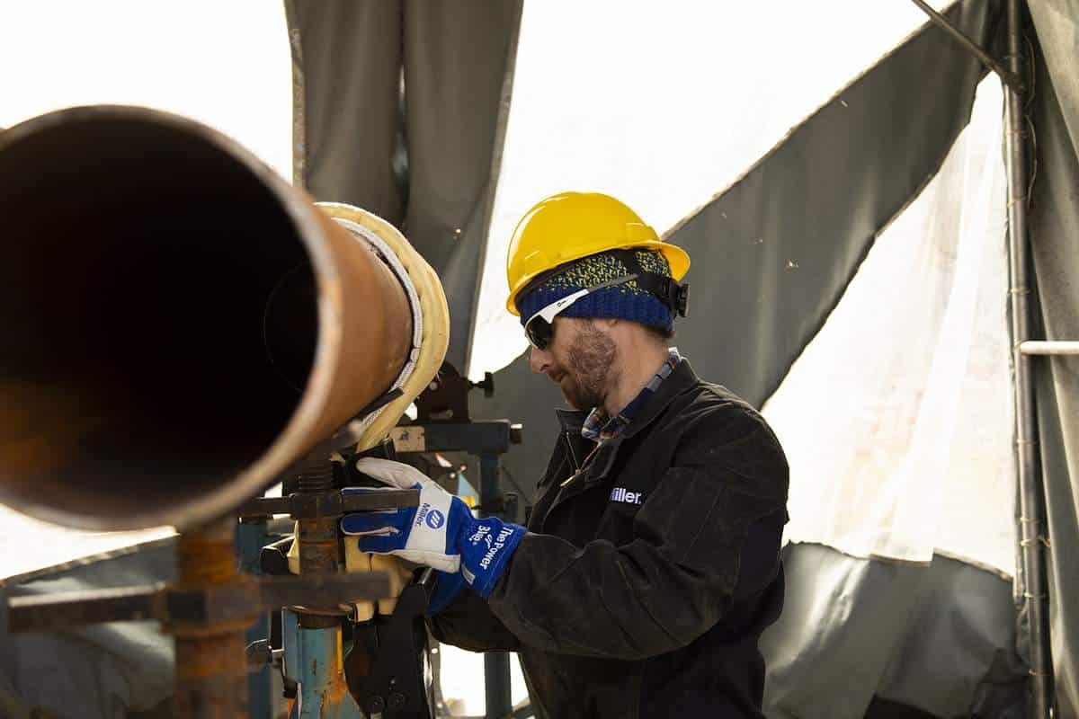 Miller Electric Worker working on a pipeline using induction heating