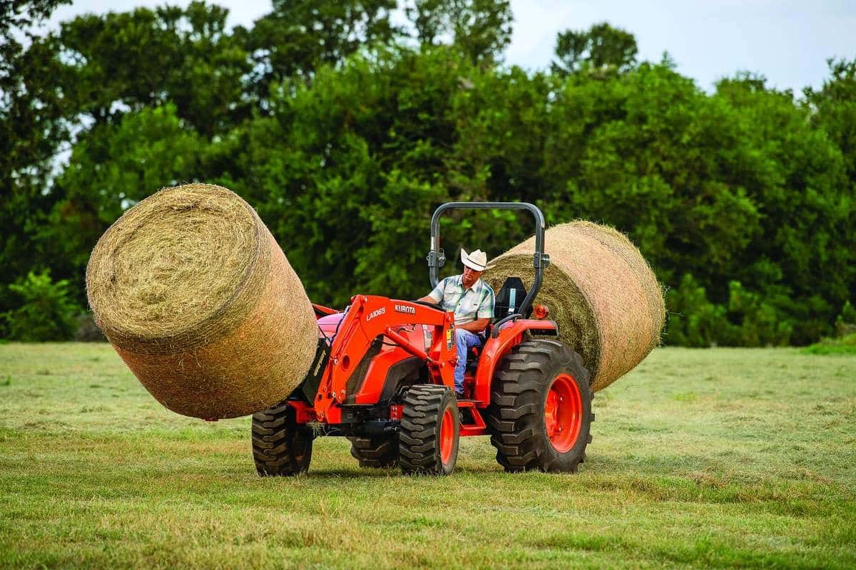 Kubota MX Series tractor with hay hales on both ends of the tractor