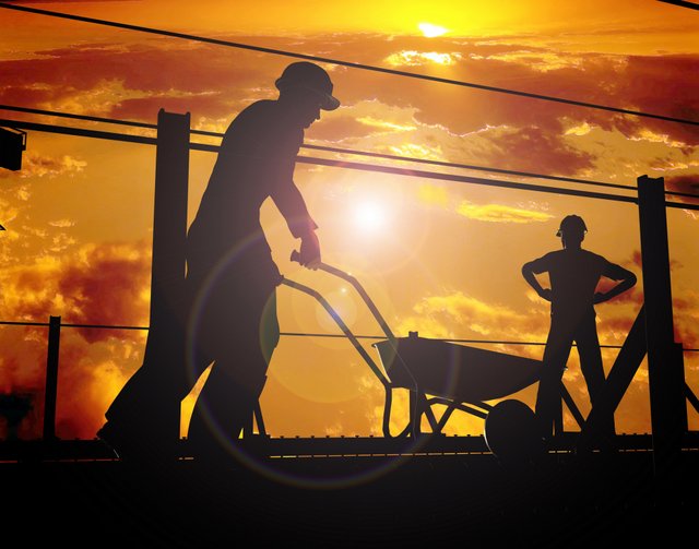 construction workers wheelbarrow sunset